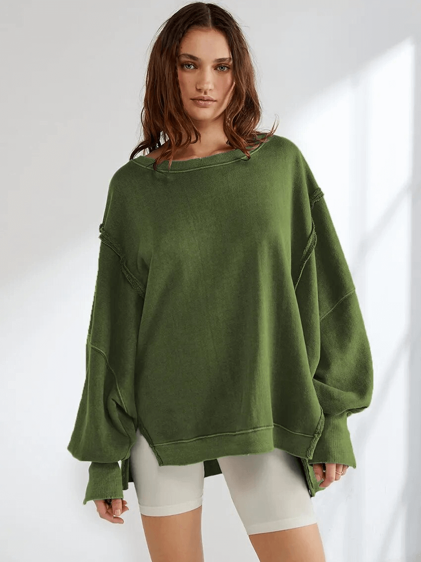 Woman wearing a green solid color drop shoulder loose sweatshirt, perfect for casual fashion. Made of polyester with a stylish O-neck.